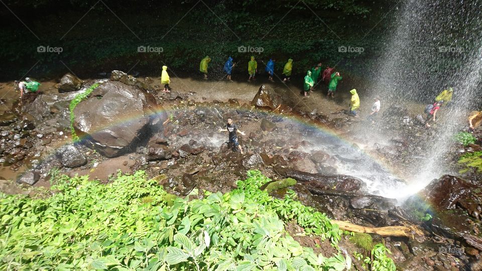 there is a rainbow in the waterfall