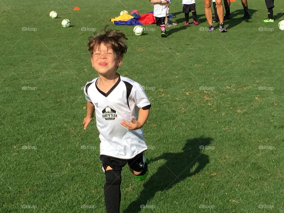 Running Happy Soccer Youth