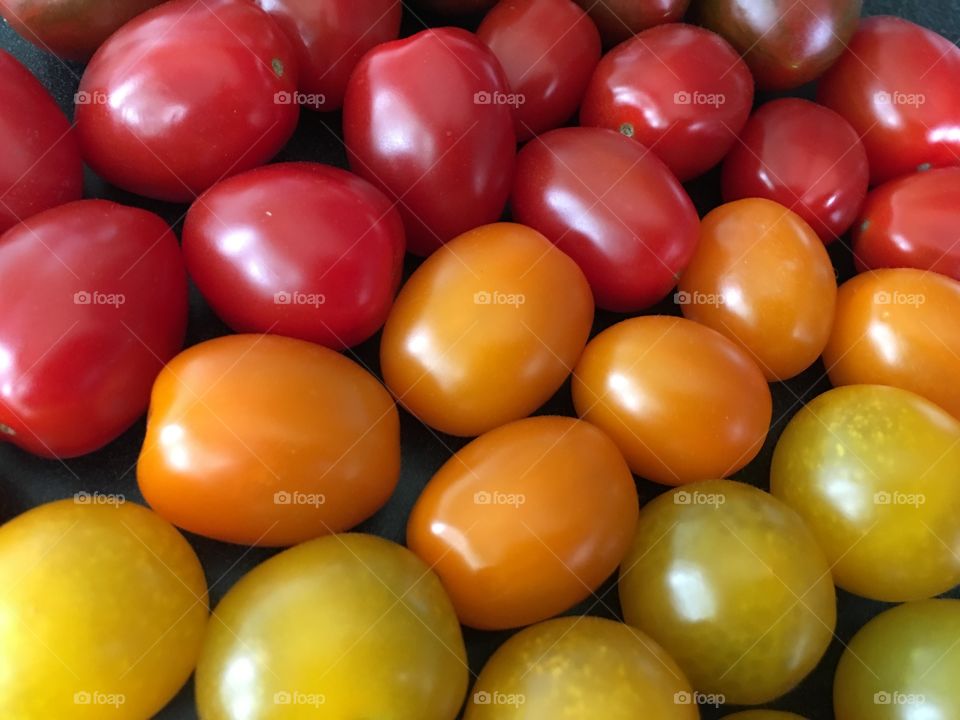 Closeup of fresh organic garden cherry tomato in red, yellow and orange colorful food texture healthy lifestyle background 