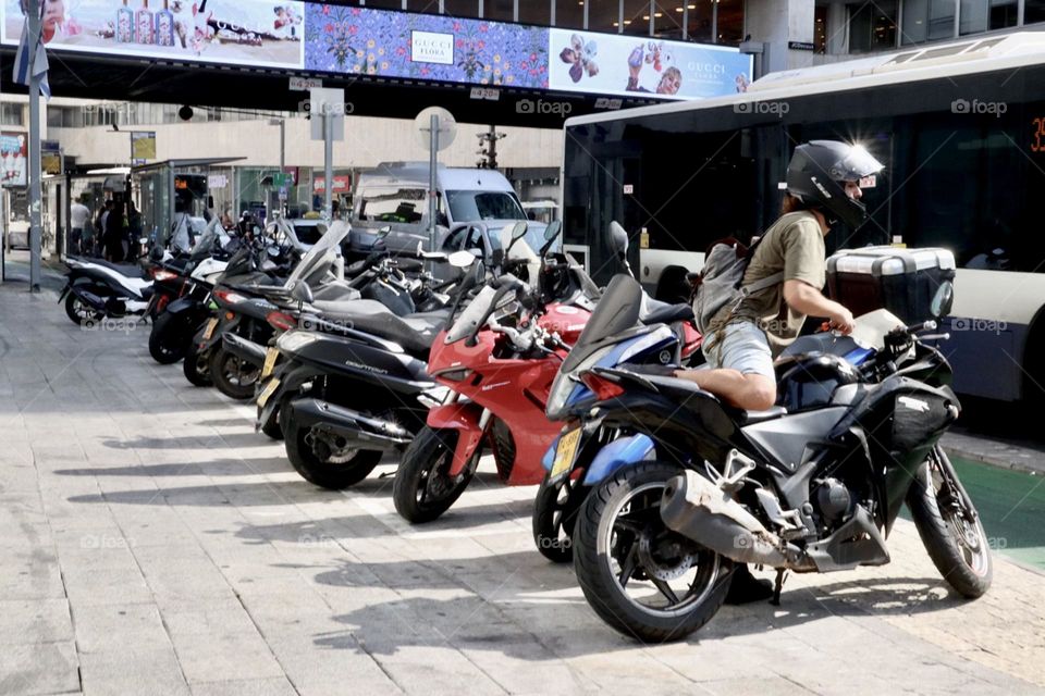 Many motorcycles on pavement 