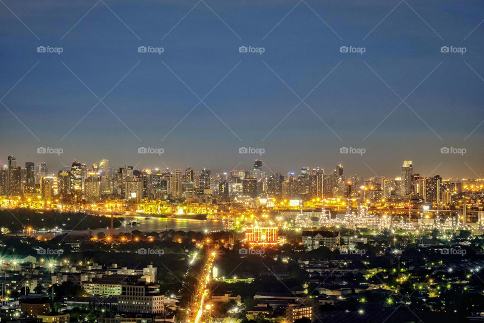 Beautiful movement line of vehicle light on road between building and skyscraper background