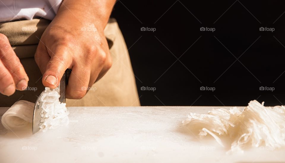 Person cutting fish for sushi