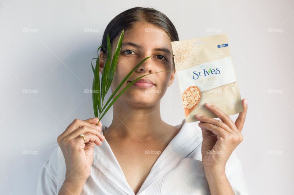 ST Ives oatmilk sheet mask held in hand.