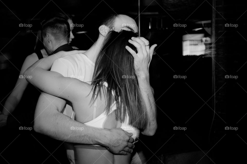 two people dancing close to each other. Black and white photo.