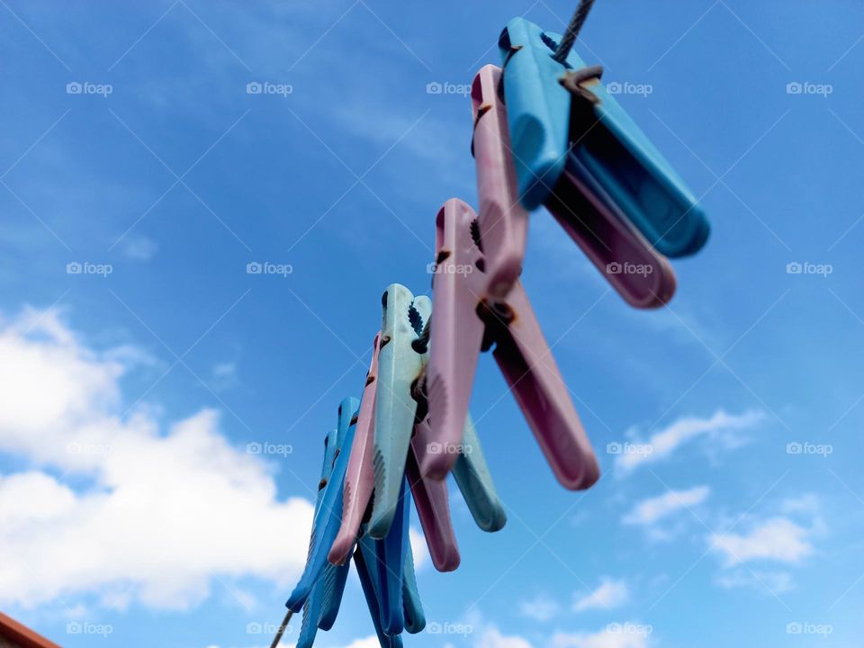 hanging clothespins against the blue sky.