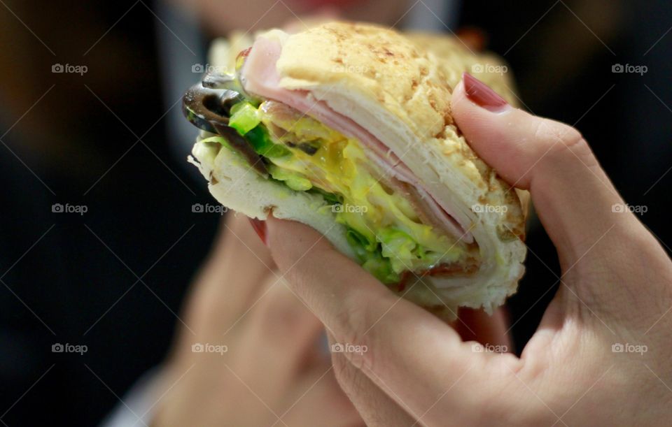 Young woman eating sandwich