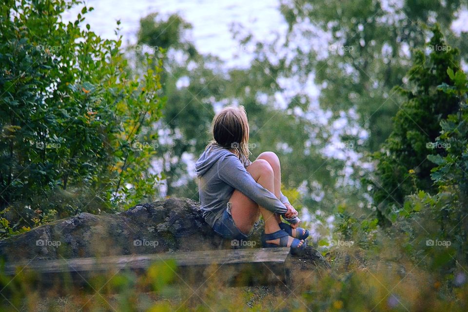 Girl sits . A girl enjoys the wonderful nature