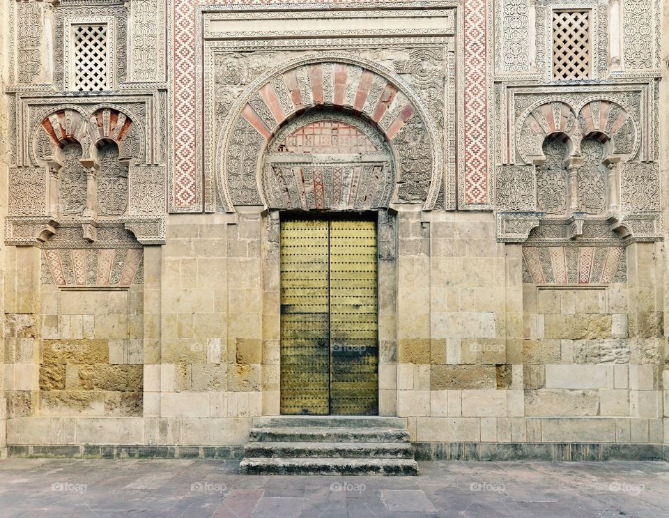 Door and wall in Córdoba . Golden door and wall with moorish decorations in Córdoba,Spain.