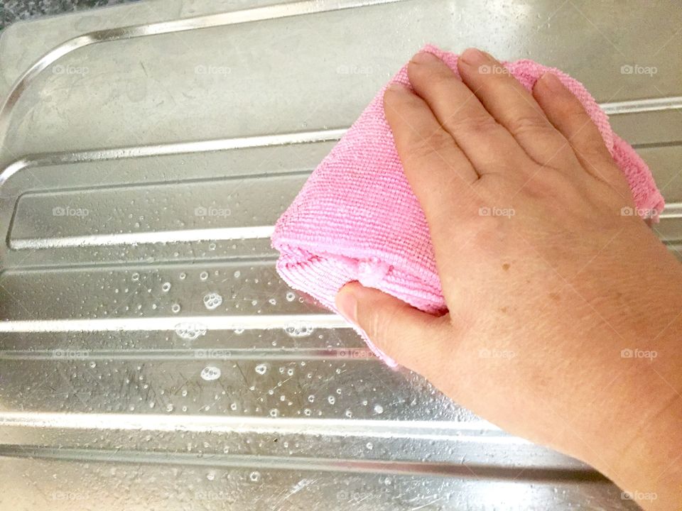 Close-up of a girl's hand cleaning sink