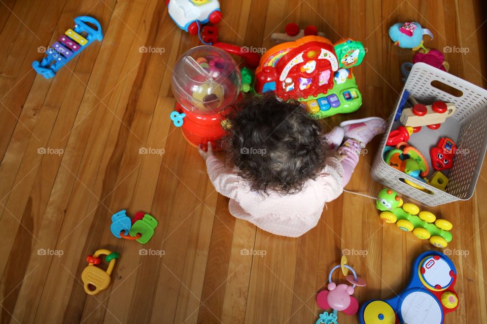 This is just one regular day of my baby playing with her toys .