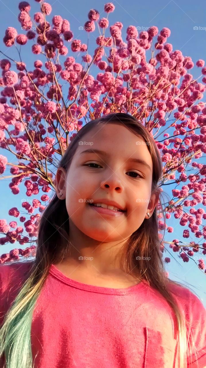 Girl under the pink tree