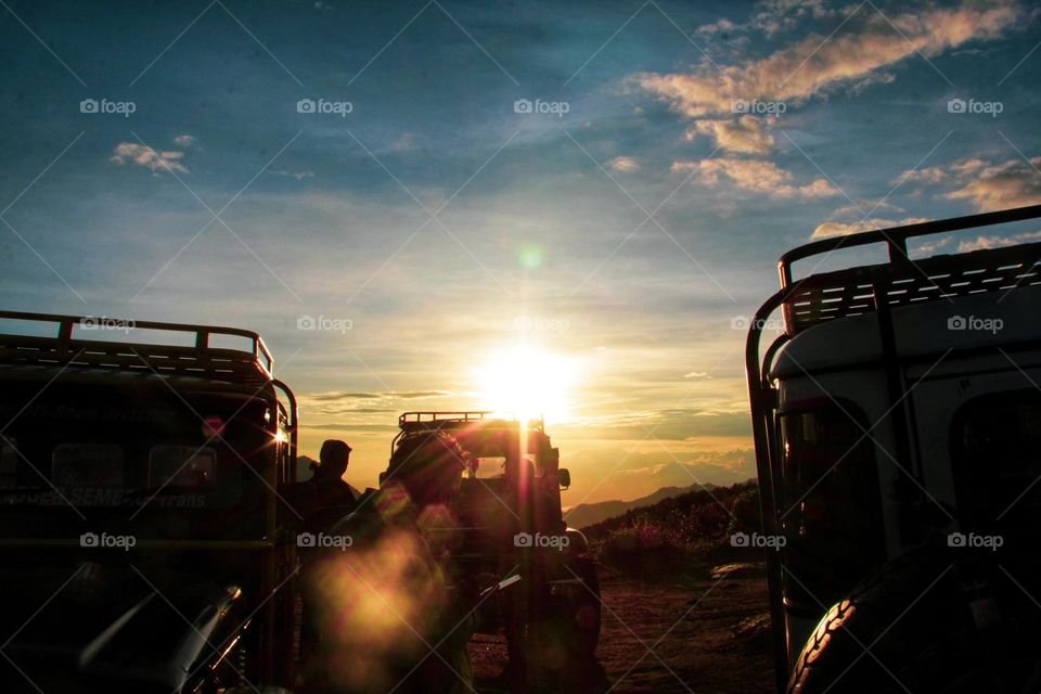 Sunrise that illuminates the car parking area on a hill in the Bromo mountains, East Java.