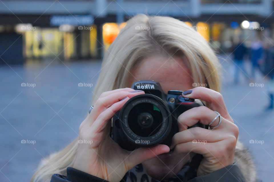 a women with a camera in front of her