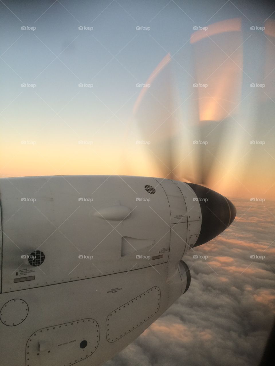 Sunset reflected off propellor. I took this photo when I was flying  back to Sydney from rural New South Wales after a work trip. 
