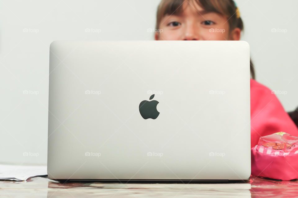 Cute child is using a MacBook