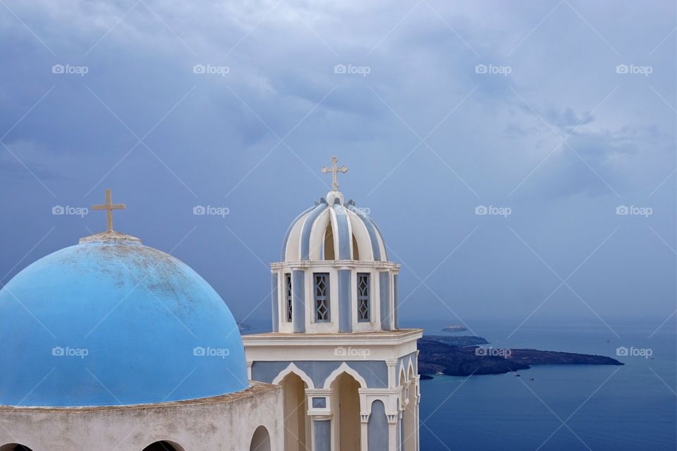 Pretty blue dome and bell tower of a church near Fira, Santorini, Greece 