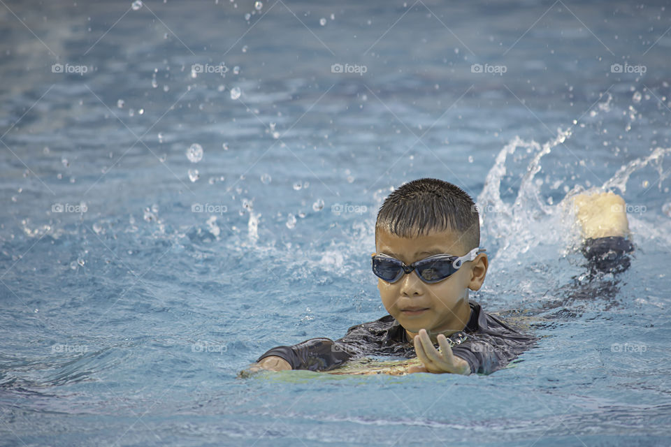 Asean boys are swimming in the pool.