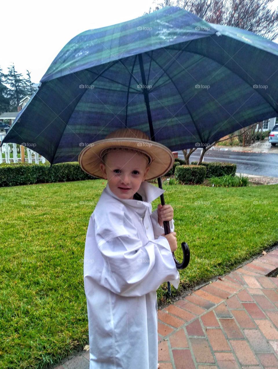 After the California fires 2018 and the end of November we finally get some rain my adorable nephew enjoying the rain as I caught him playing outside with the umbrella in the rain