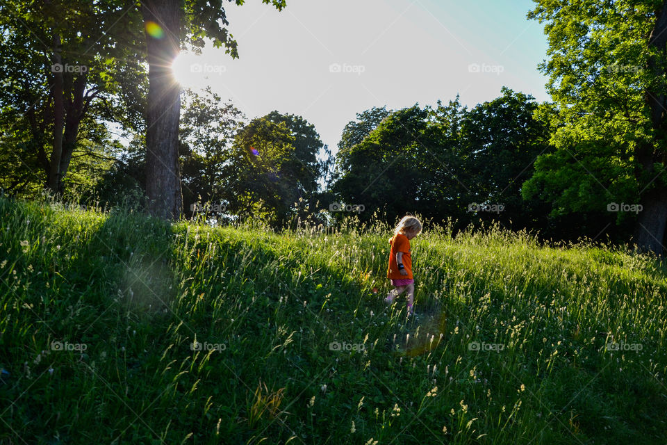 Little girl walking in field