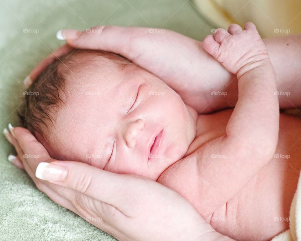 Mother hand holding her baby