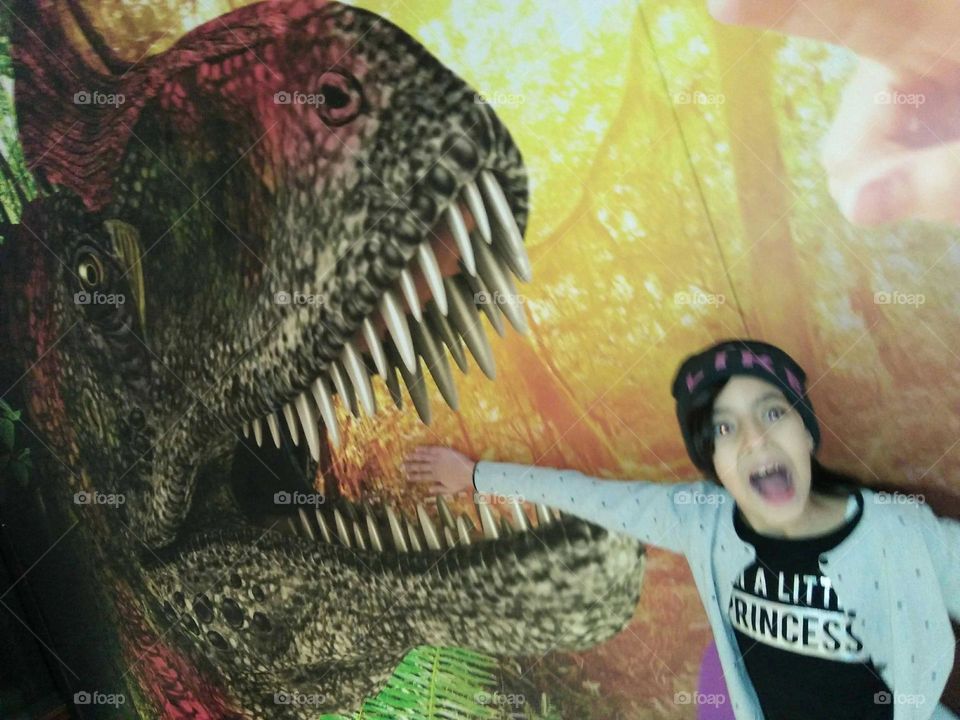 brave girl  against dinosaur