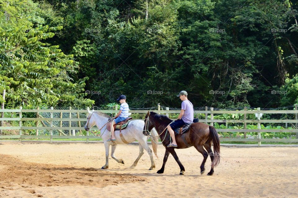 Countryside - father and son riding a horse