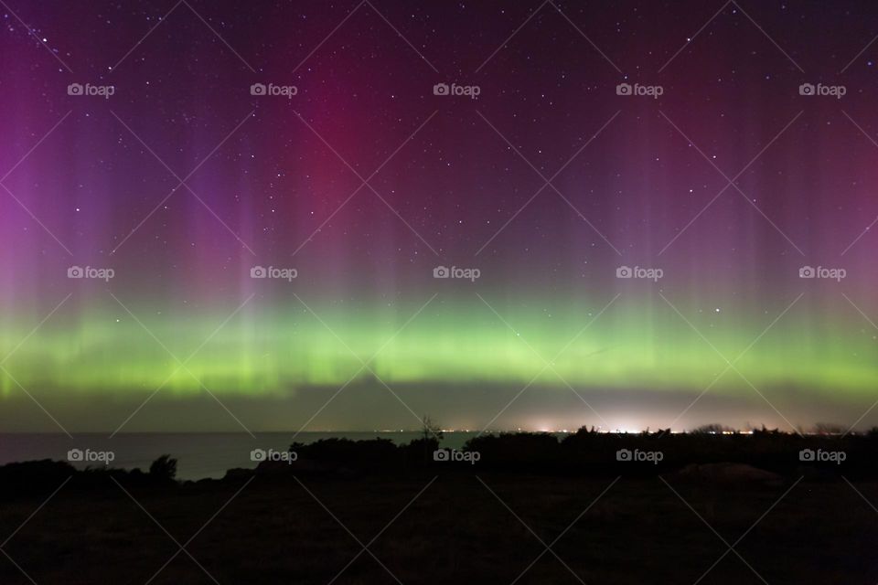 Colorful northern light over the ocean in Sweden 