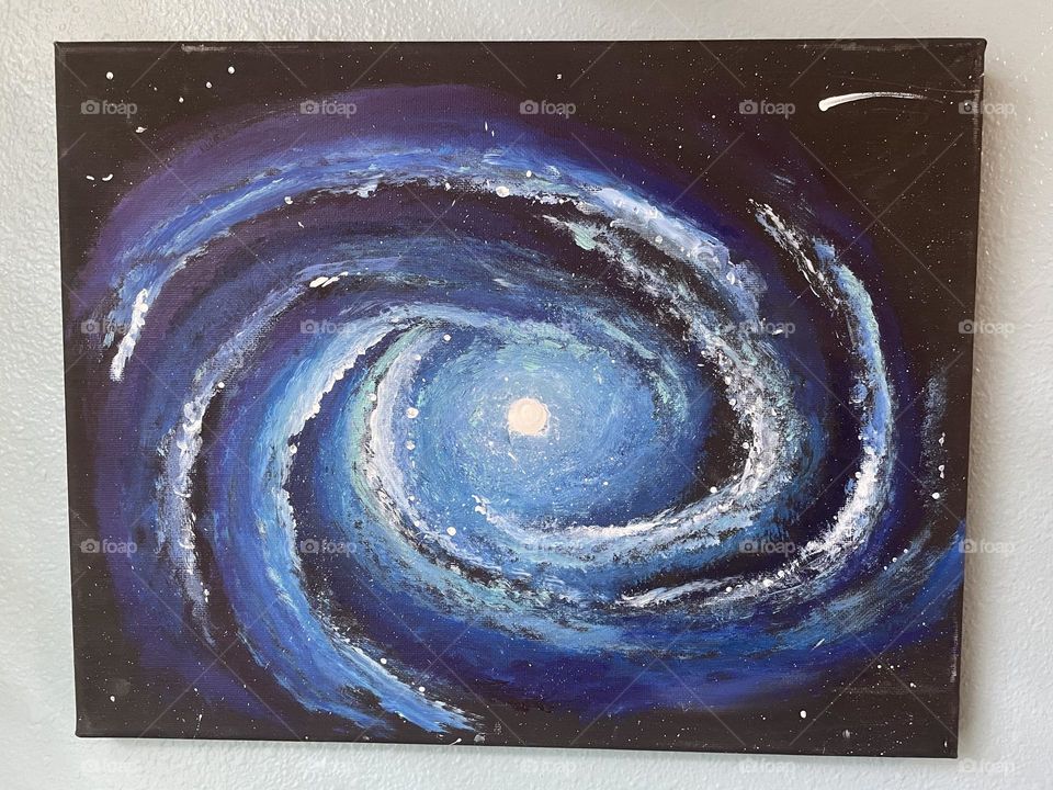 A homemade spiral Galaxy painting with blue and purple colors