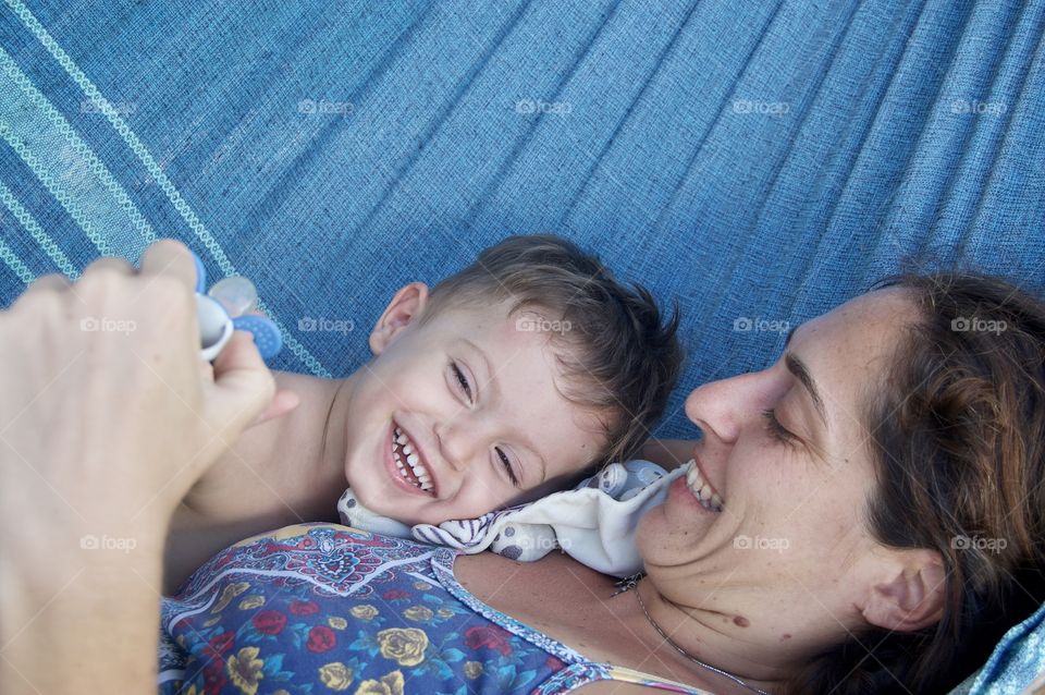 Mum and son smiling in the hammock.
