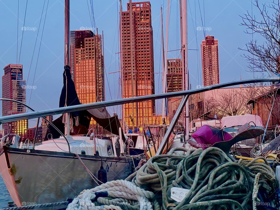 This dramatic impression comes to us from “Newtown Creek” by the “Pulaski Bridge” in LIC, Queens. As the sun sets its orange to red rays reflect in the solid glass facades of various high rise buildings under construction. 2023. Hypnotic Productions