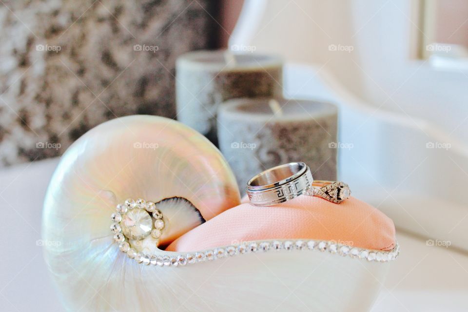 These are our gorgeous wedding rings on a shell ring holder 