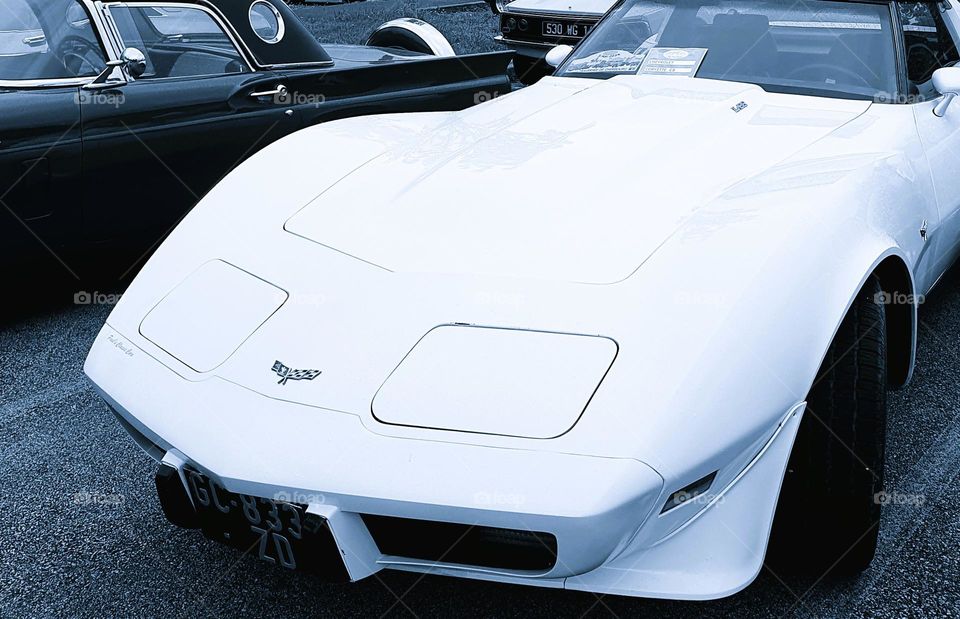 Cool light shot of the front of a Chevrolet Corvette at Cherbourg car show