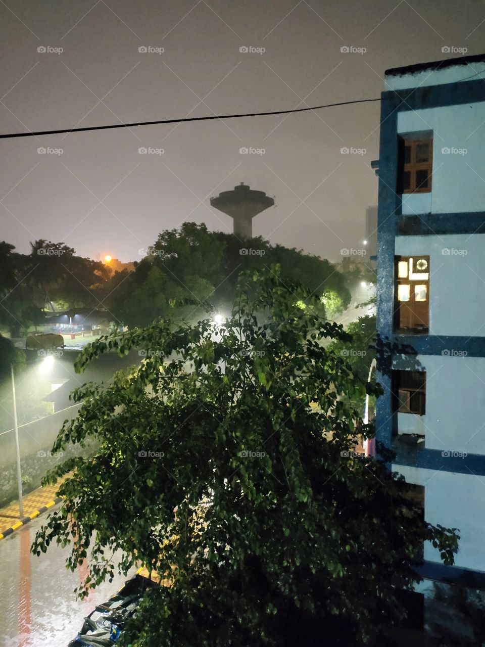 Pleasent Weather During Heavy Rain
Night Scene Towards City
it's Combination of Nature
e.g.
Super illumination,
Rain Drops,Green Tree ,Flats corner and Water tank...