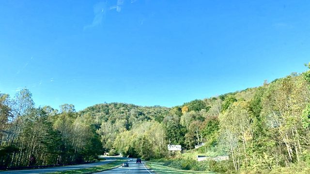 I love how tiny the cars look against the beautiful mountain and blue sky. This was on the way to North Carolina.
