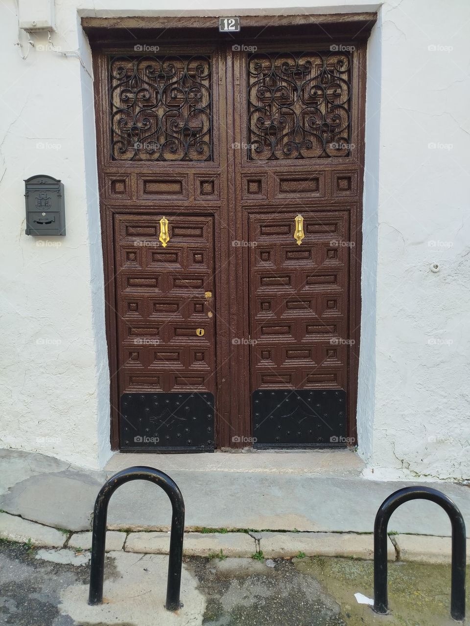 spectacular old wooden door with decorative details that enhance its beauty, color and strength