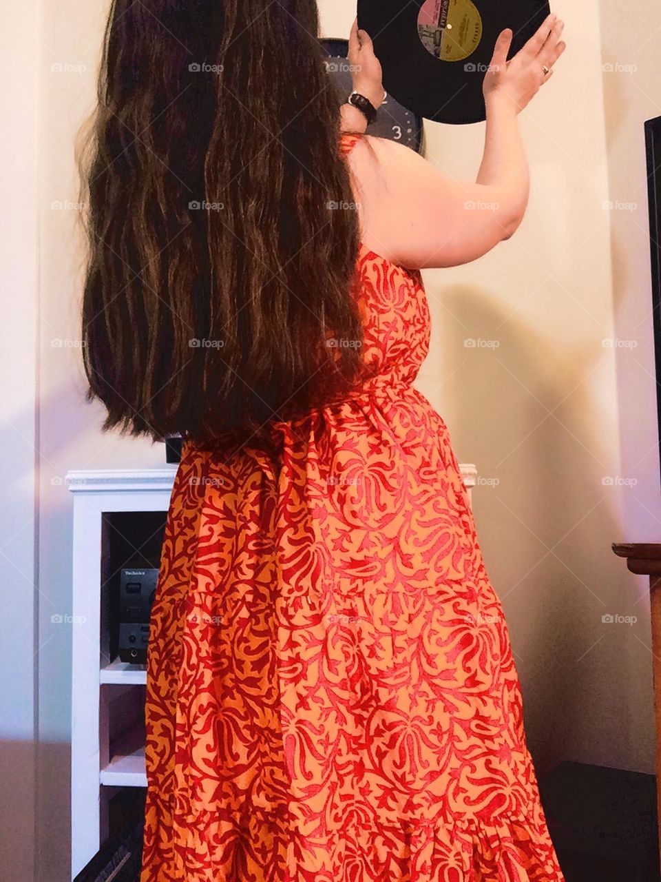 Woman putting a record on wearing a summer dress