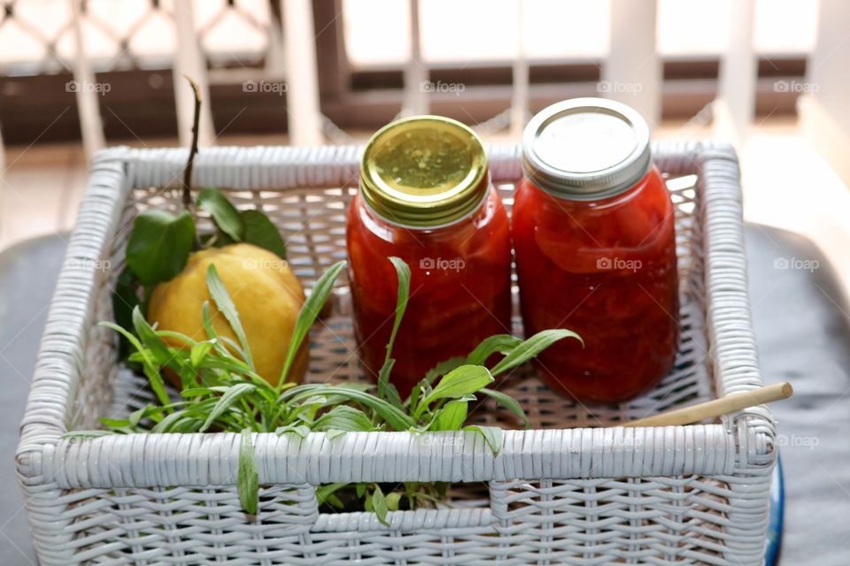 Quince fruit preserves quart jars (2) in rustic white wicker basket 