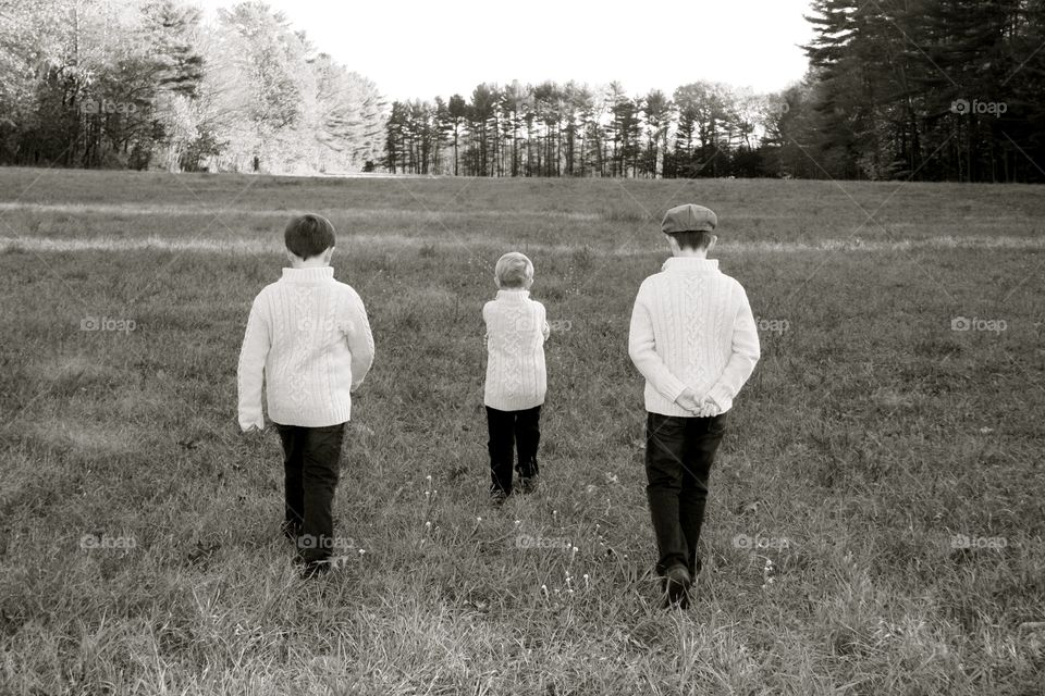 Boys walking in field 