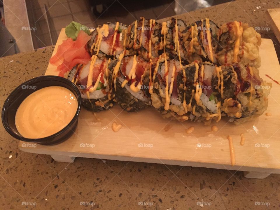 Nothing better than seaweed wrapped spicy tuna sushi dribbled with a spicy mayo sauce! Displayed on a wooden block garnished with wasabi paste, pickled ginger and mayo sauce!