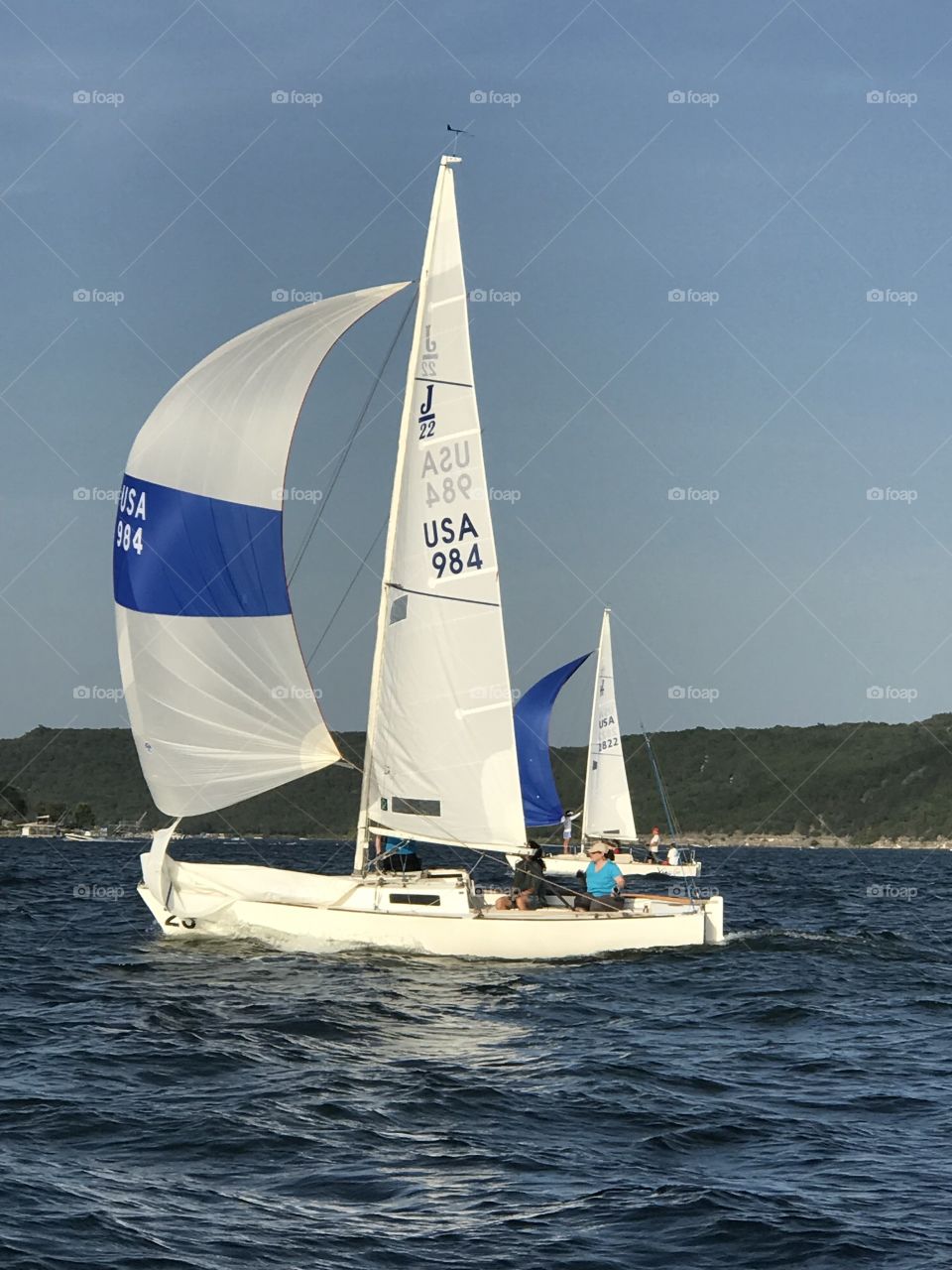 J22 Sailing in Sailboat Race with spinnaker on downwind run