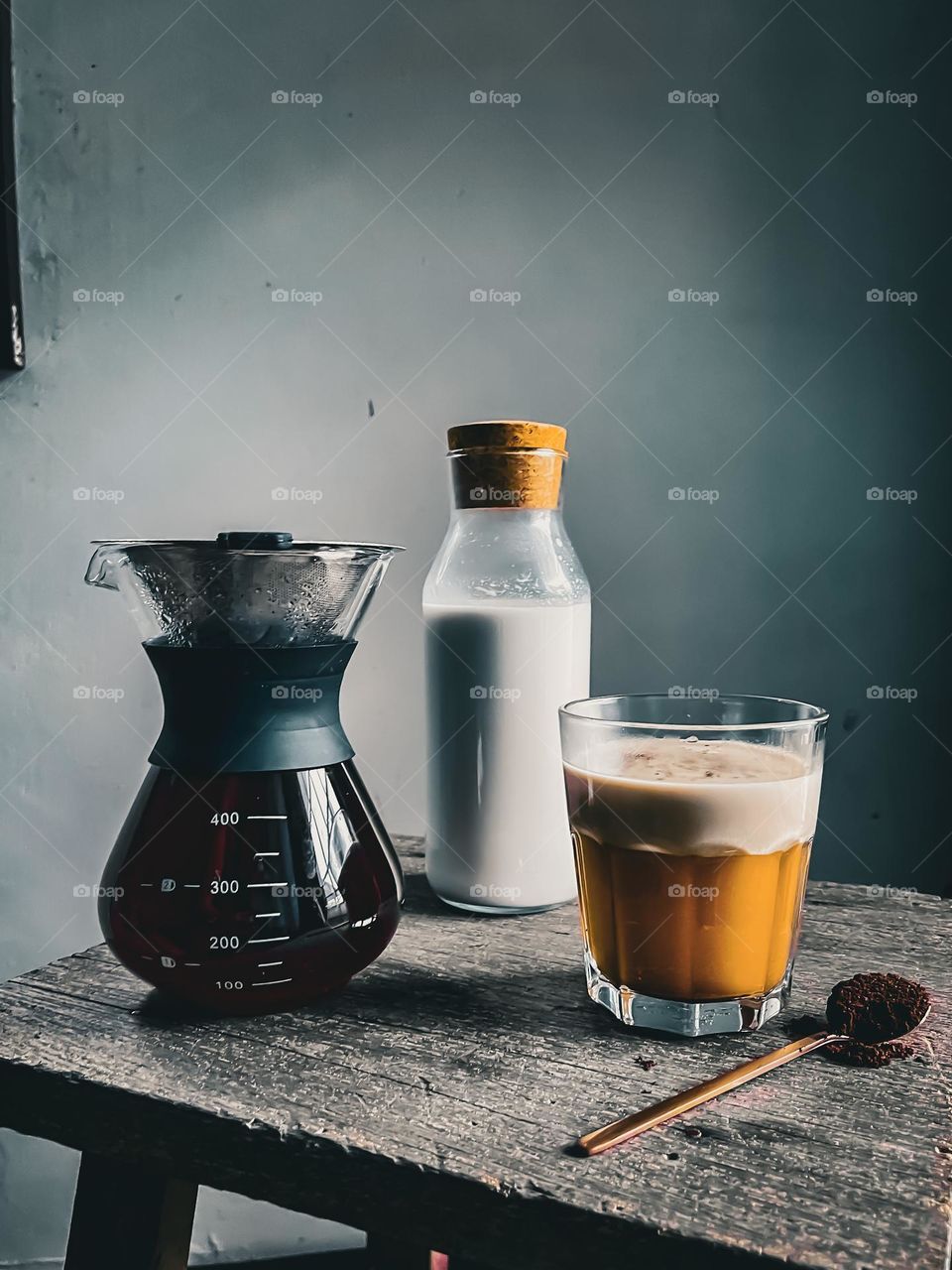 Coffee milk preparation, close up view with a bottle of milk and coffee dripper