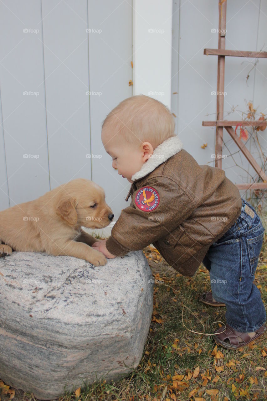 Baby and puppy. Baby meeting the puppy