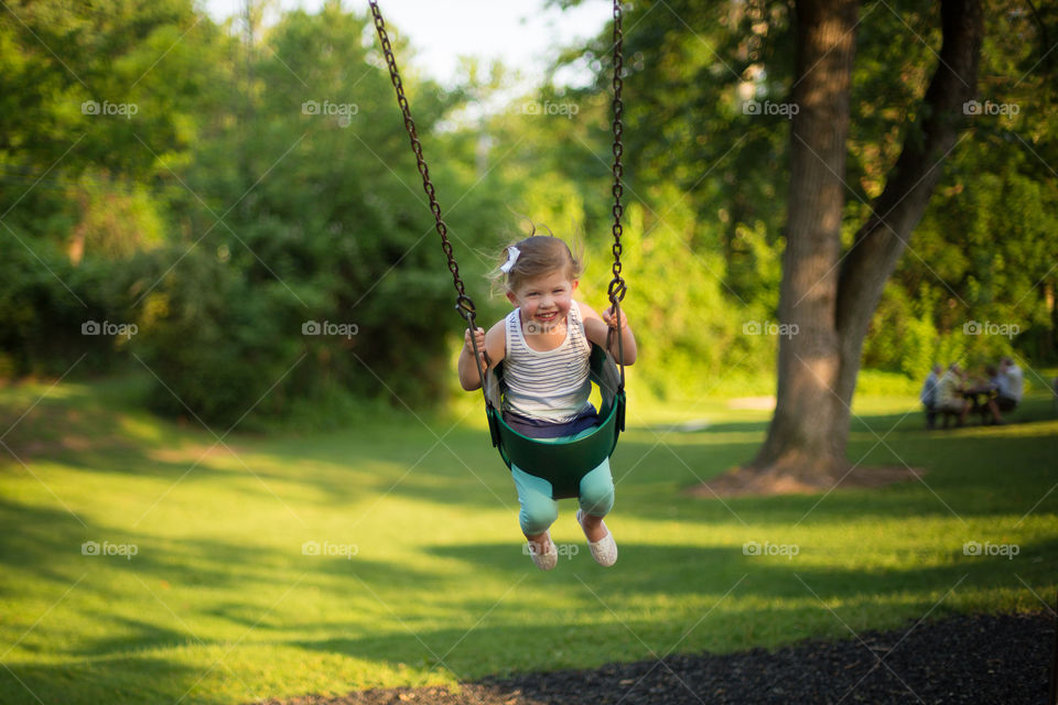 View of girl swinging on swing