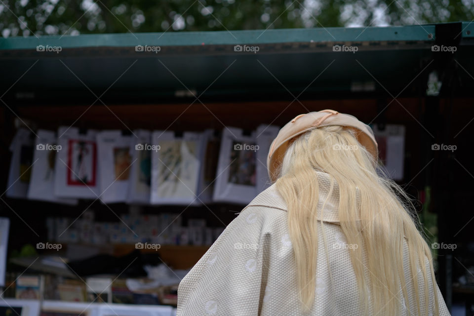 Elderly woman looking at the street books store