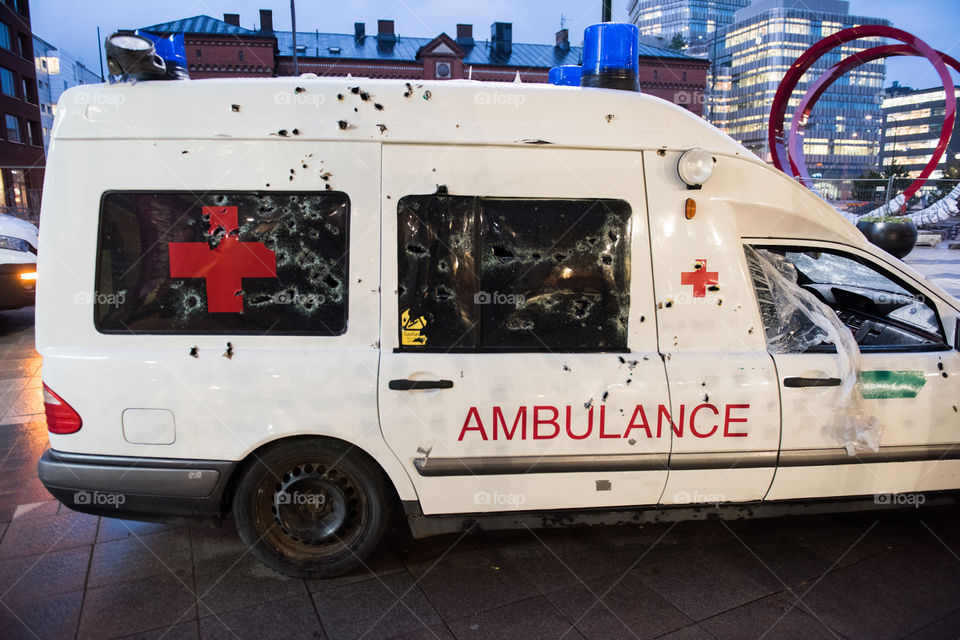 A real ambulance from the Red Cross who had been attacked in war. The Ambulance has bulletholes just everywhere and even firebombs have been thrown against it. The ambulance is part of efforts to make people aware of what happens in war. Ambulance shown up in various parts of the world. The picture is from Malmö Sweden.