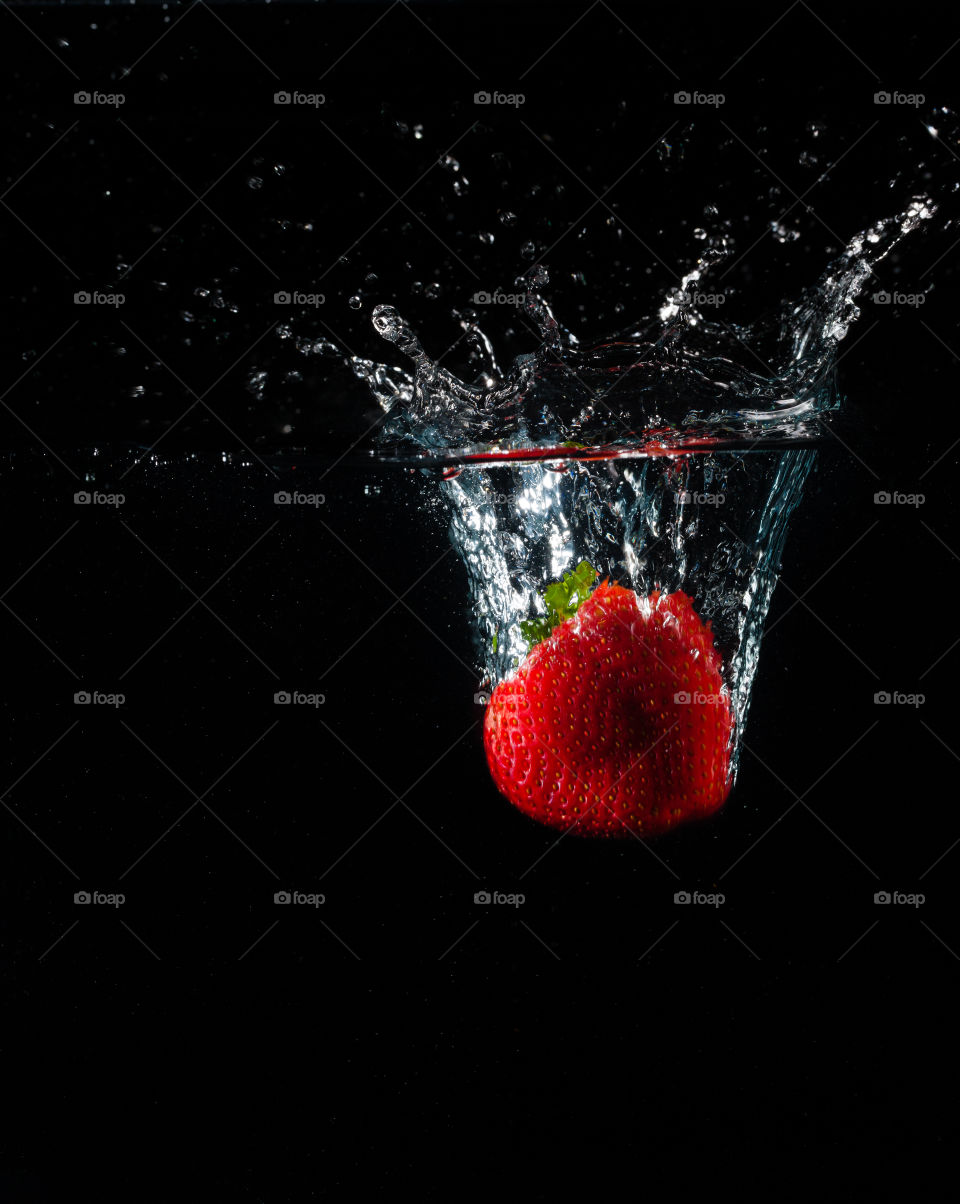 Strawberry splashing in water