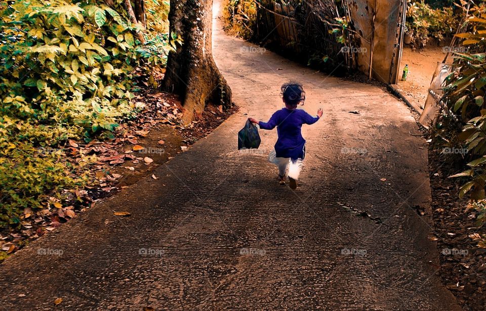 beautiful little girl running with happiness in autumn season