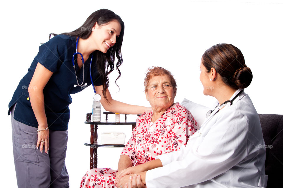 Doctor and nurse consulting senior patient