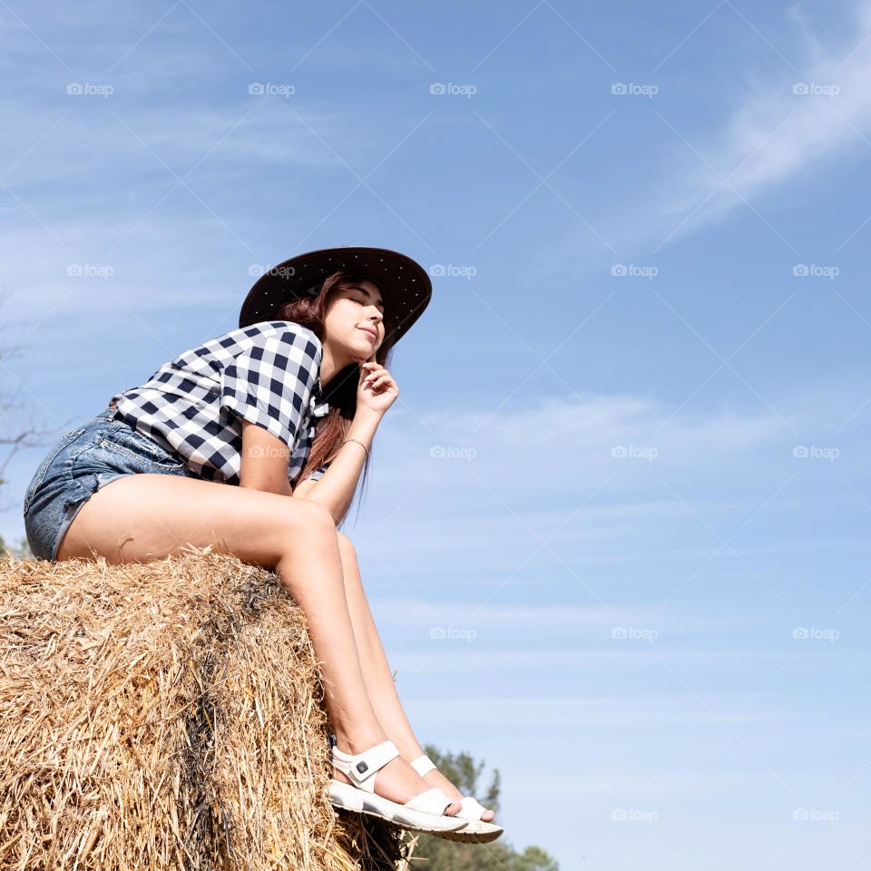 woman on hay stack