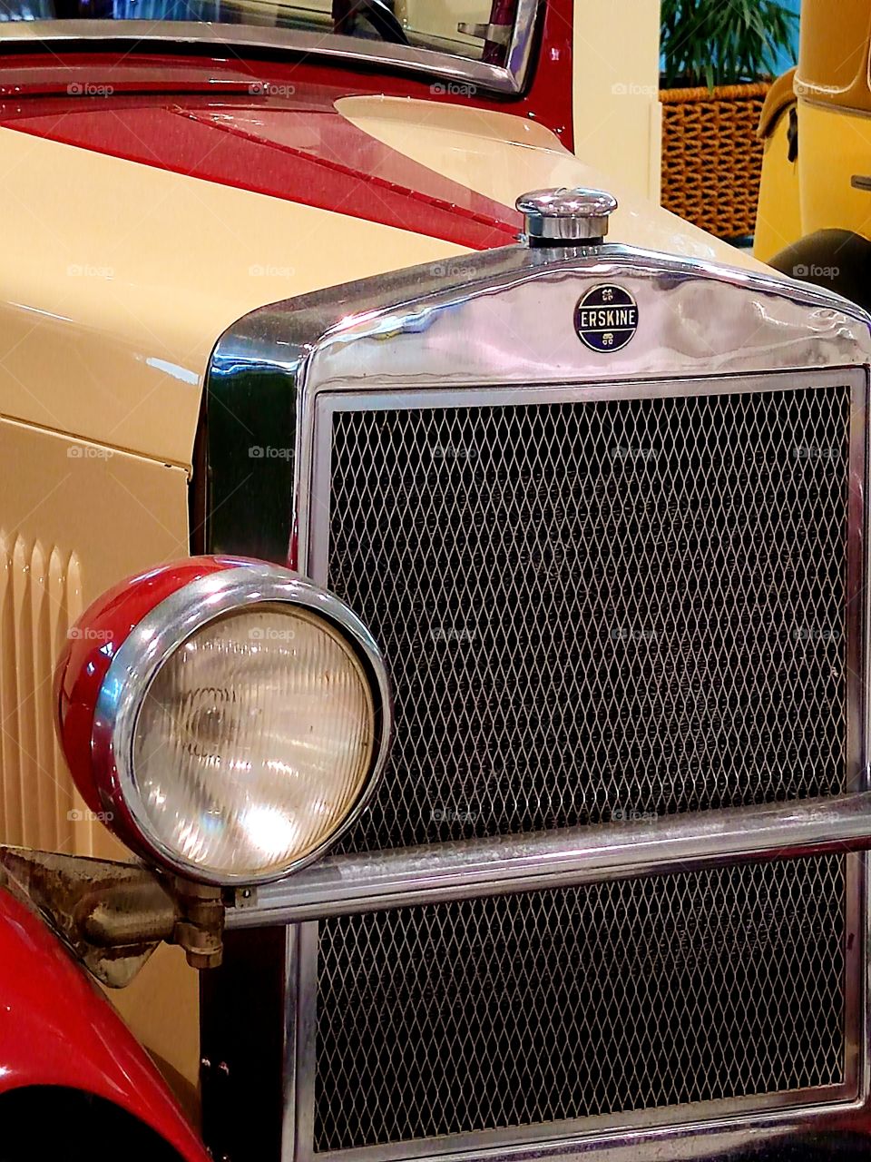 Red and beige car.  "Studebaker Erskine 50 Sedan".  USA. 1927.  Close-up front view.  logo and emblems.  Retro cars